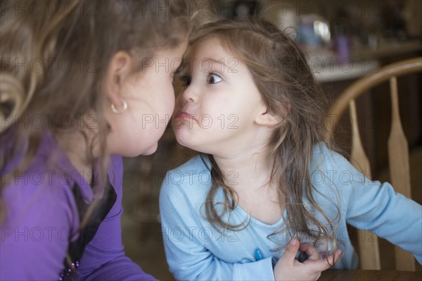 Sisters making faces at each other