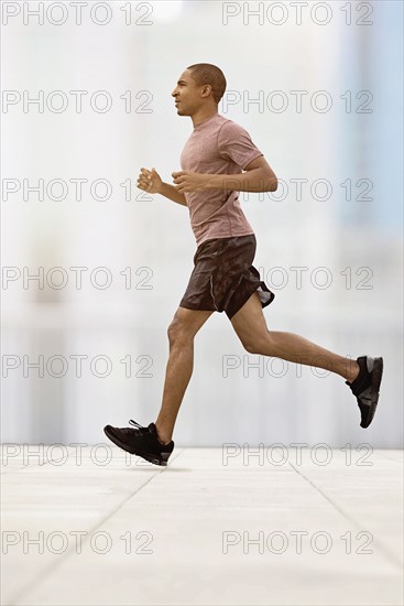 Mid adult man running.
