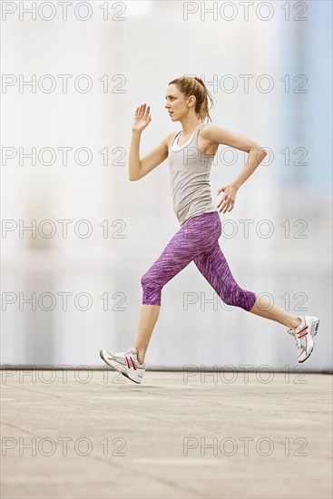 Mid adult woman running.