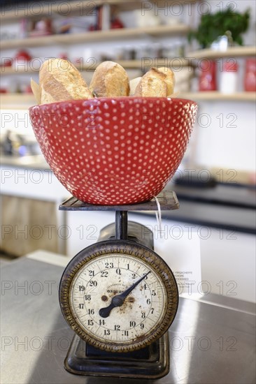 Close-up of red bowl on scale.