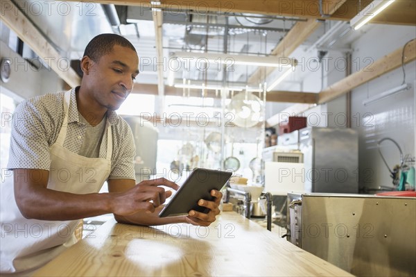 Bakery owner using digital tablet.