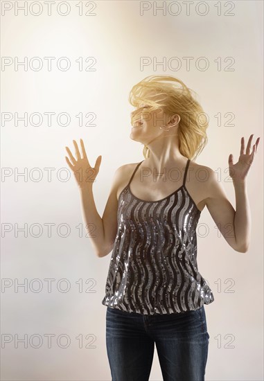 Happy woman dancing in studio.