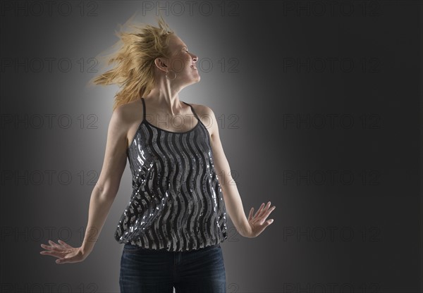 Happy woman dancing in studio.