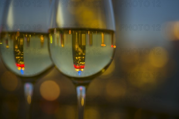 Two wineglasses with white wine. USA, New York, New York City.