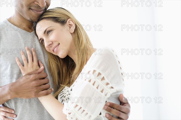 Mid adult couple embracing.