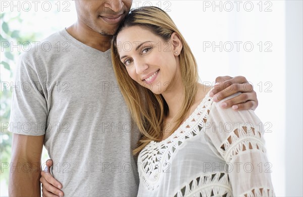 Mid adult couple embracing.