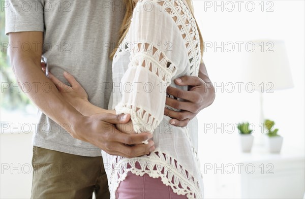 Mid adult couple embracing.