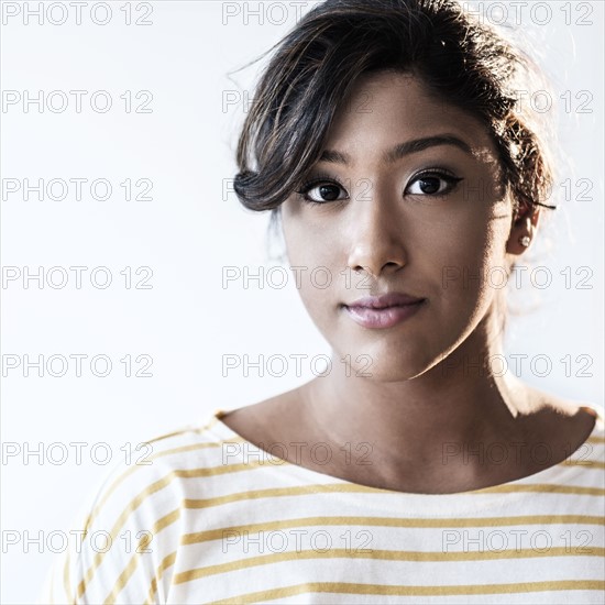 Portrait of young woman in studio.