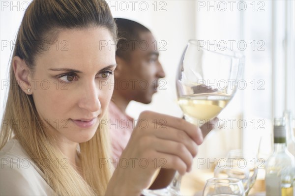 Man and woman tasting white wine.