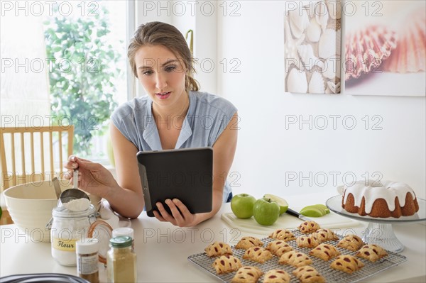 Young woman baking in kitchen.