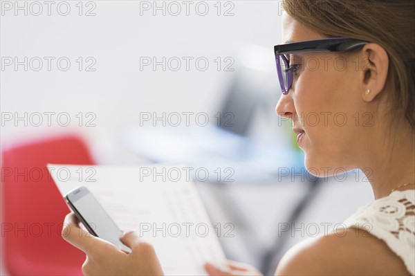 Young woman using mobile phone.