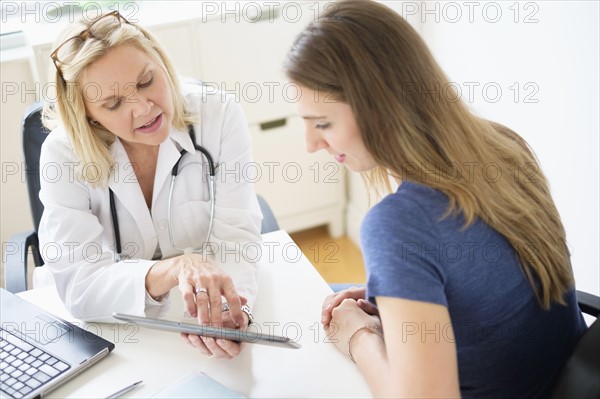 Doctor talking to patient in office.