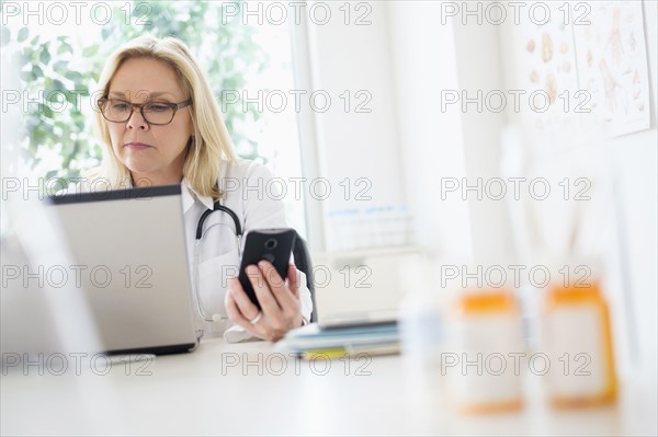 Doctor working with laptop in her office.