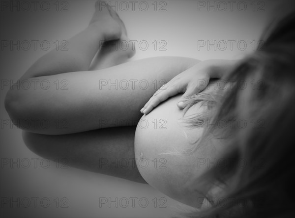 Studio shot of naked, pregnant woman