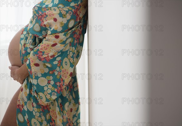 Pregnant woman in colorful dressing gown