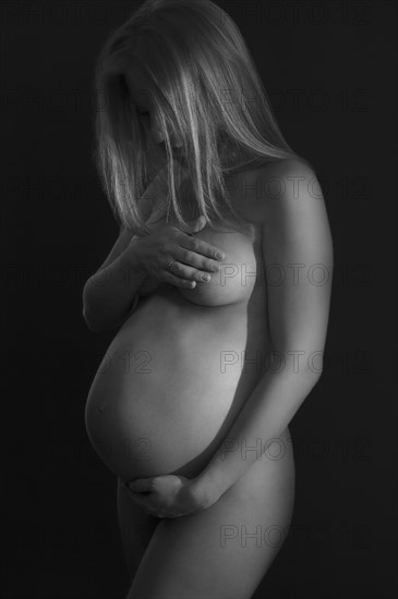 Studio shot of naked pregnant woman
