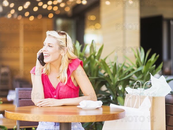 Woman talking on phone in cafe