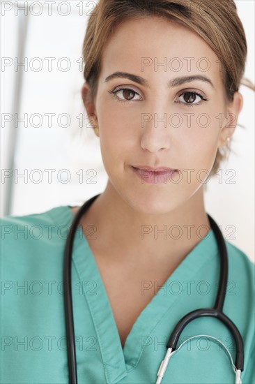 Young female doctor in hospital corridor.