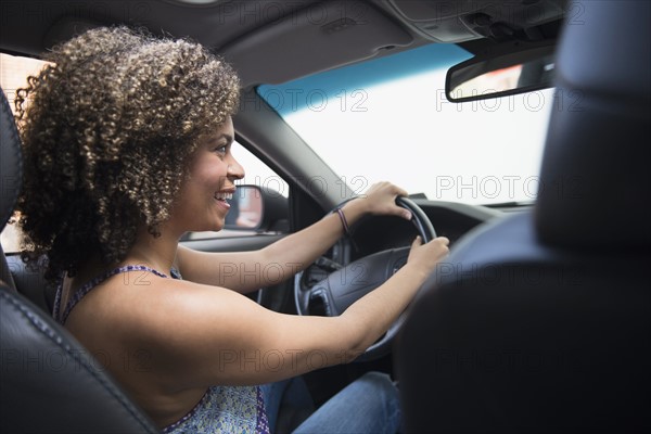 Young woman driving car.