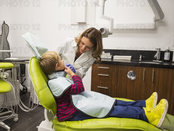 Dentist and patient (8-9) in dentist's office