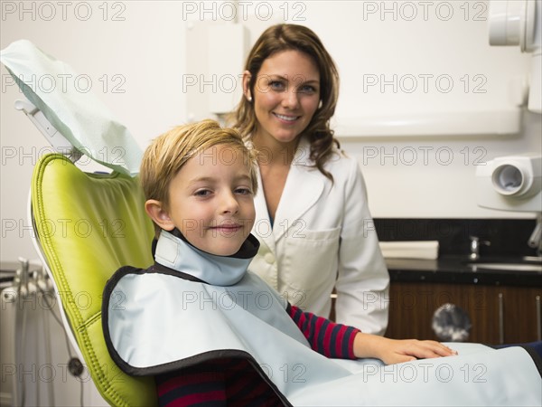 Dentist and patient (8-9) in dentist's office