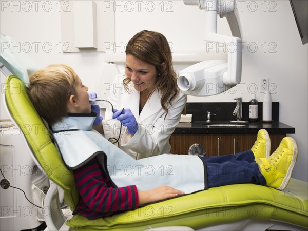 Dentist and patient (8-9) in dentist's office