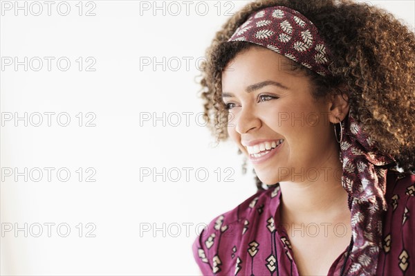 Portrait of smiling woman with curly hair.