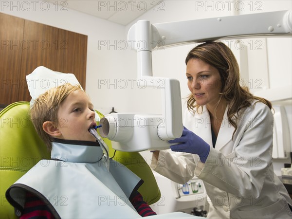 Dentist and patient (8-9) in dentist's office