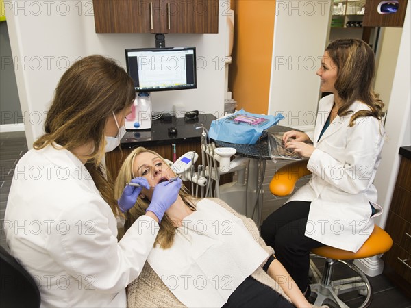 Dentists and patient in dentist's office