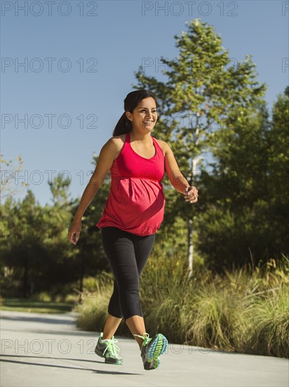 Pregnant woman walking outdoors