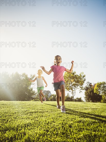 Siblings (2-3, 6-7, 8-9) playing in park