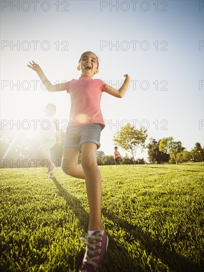 Siblings (2-3, 6-7, 8-9) playing in park