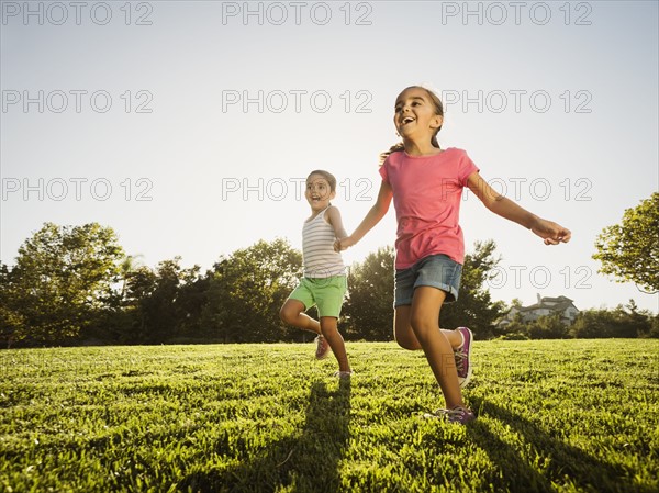 Sisters (6-7, 8-9) playing in park