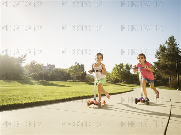 Sisters (6-7, 8-9) playing in park