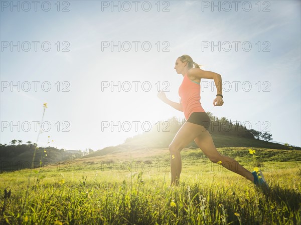 Woman running in field