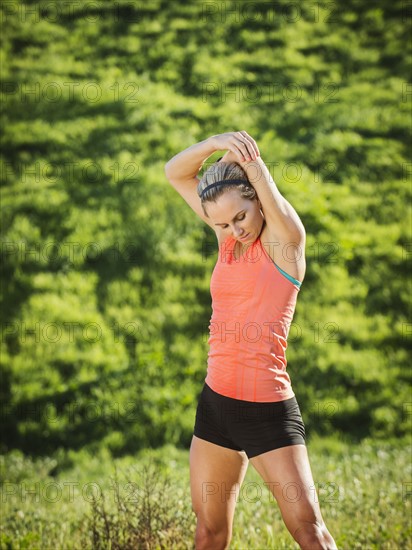 Woman exercising in field