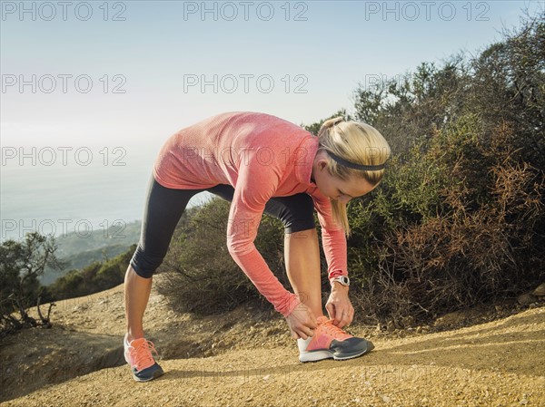 Woman tying shoe