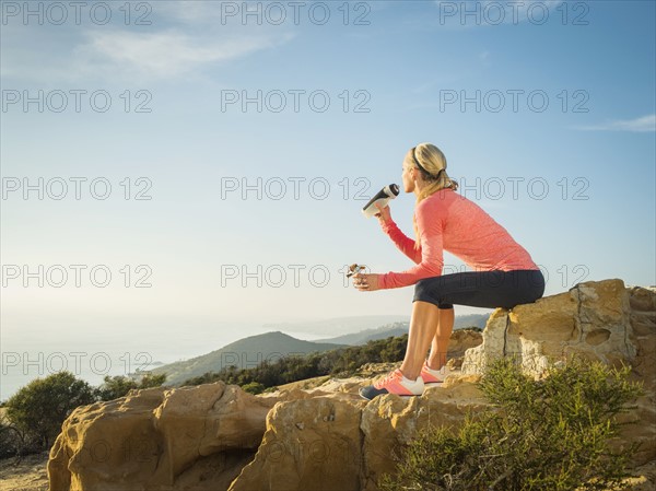 Woman in sportswear drinking water