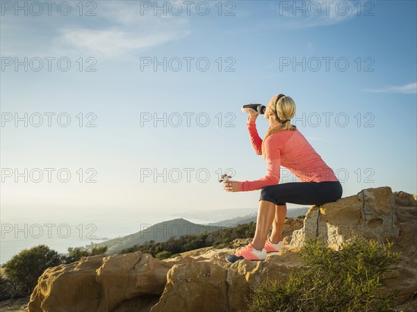 Woman in sportswear drinking water