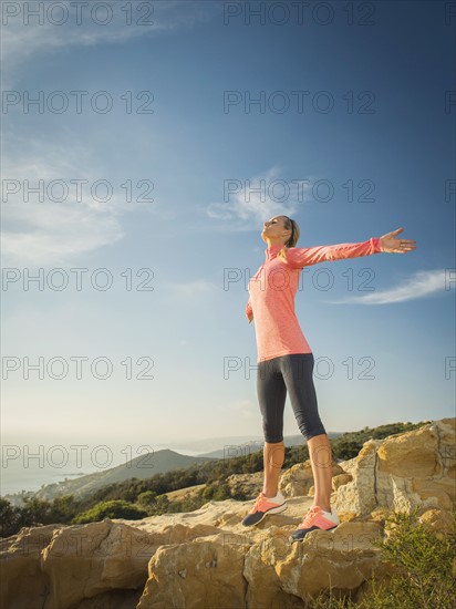 Woman in sportswear with outstretched arms