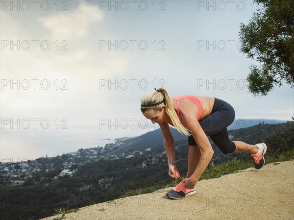 Woman tying shoe