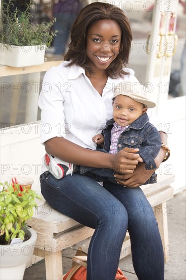 Portrait of smiling woman holding son (12-17 months)