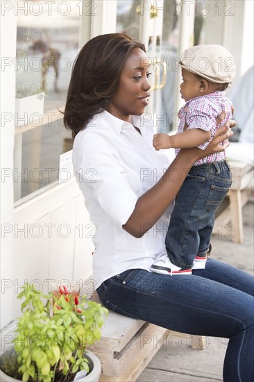 Portrait of smiling woman holding son (12-17 months)