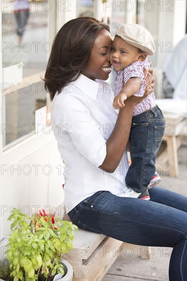 Portrait of smiling woman holding son (12-17 months)