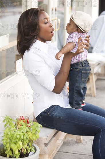 Portrait of smiling woman holding son (12-17 months)