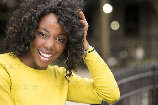 Smiling woman with hand in hair