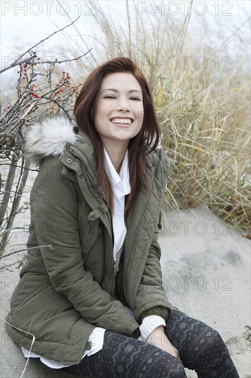 Portrait of woman in parka on winter beach