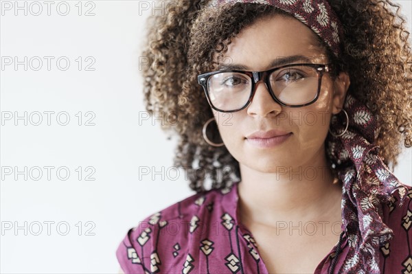 Portrait of smiling woman with curly hair.