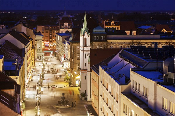 Illuminated old town street with tower of Schlosskirche