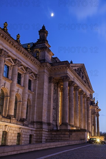 Moon over Bundestag building at dusk